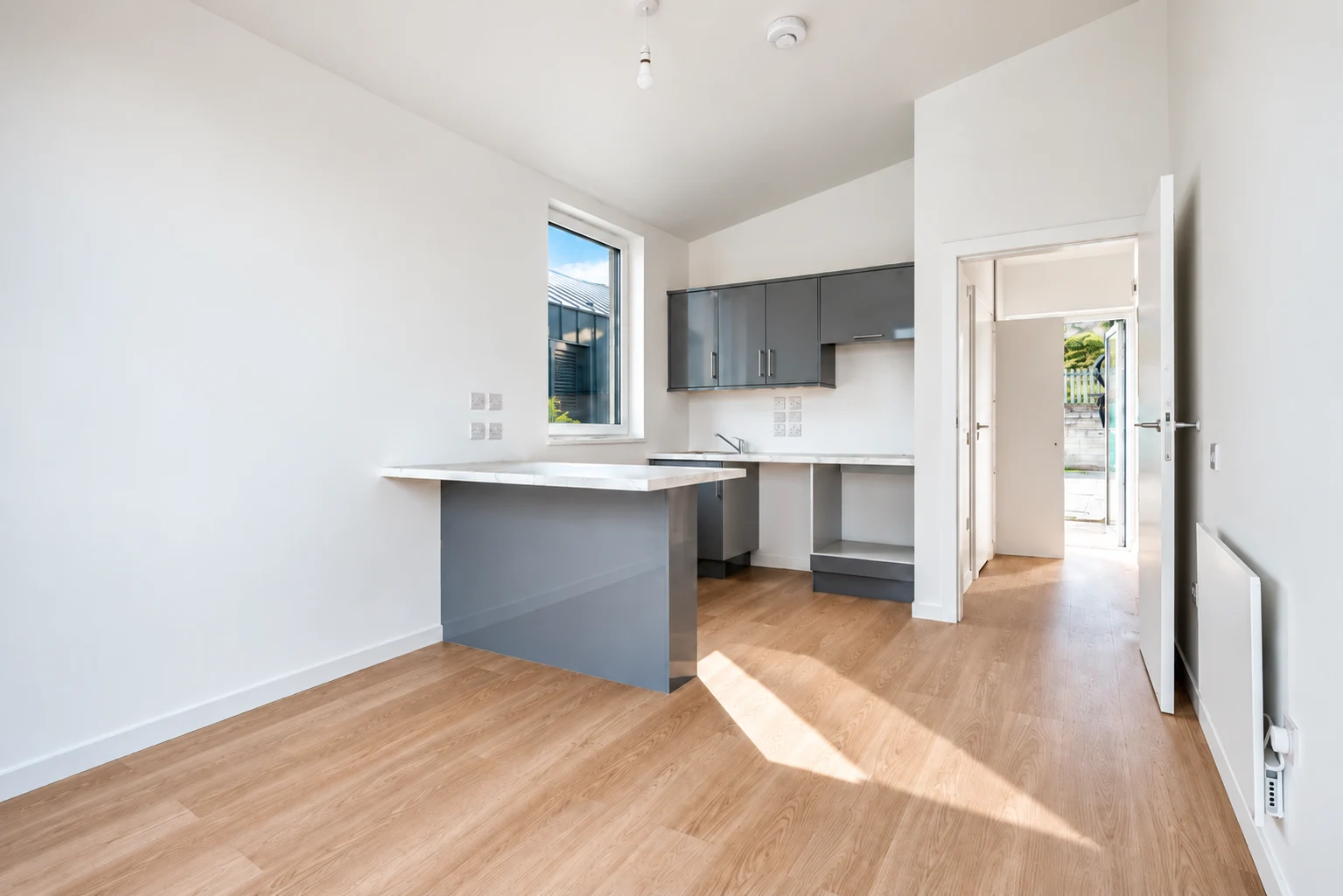 Bright open-plan modular home interior with fitted kitchen
