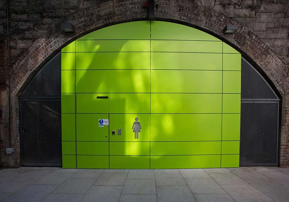 Green entrance beneath the original stone railway arch at The Arches, Tara Street