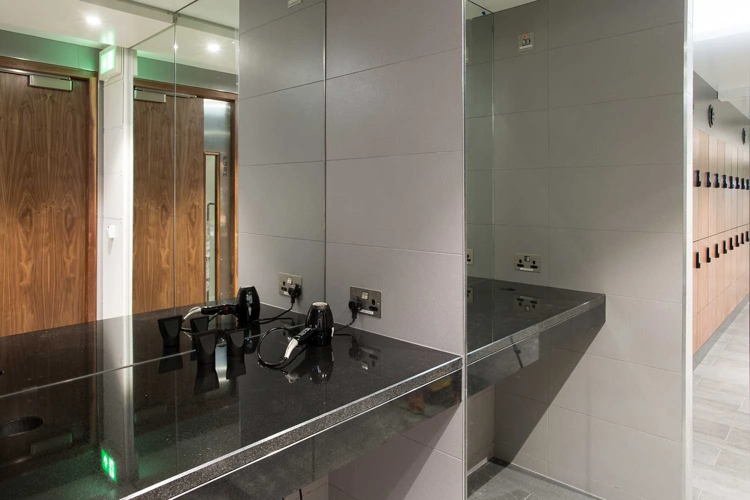 Finished washroom with basins, mirrors and adjacent lockers at The Arches